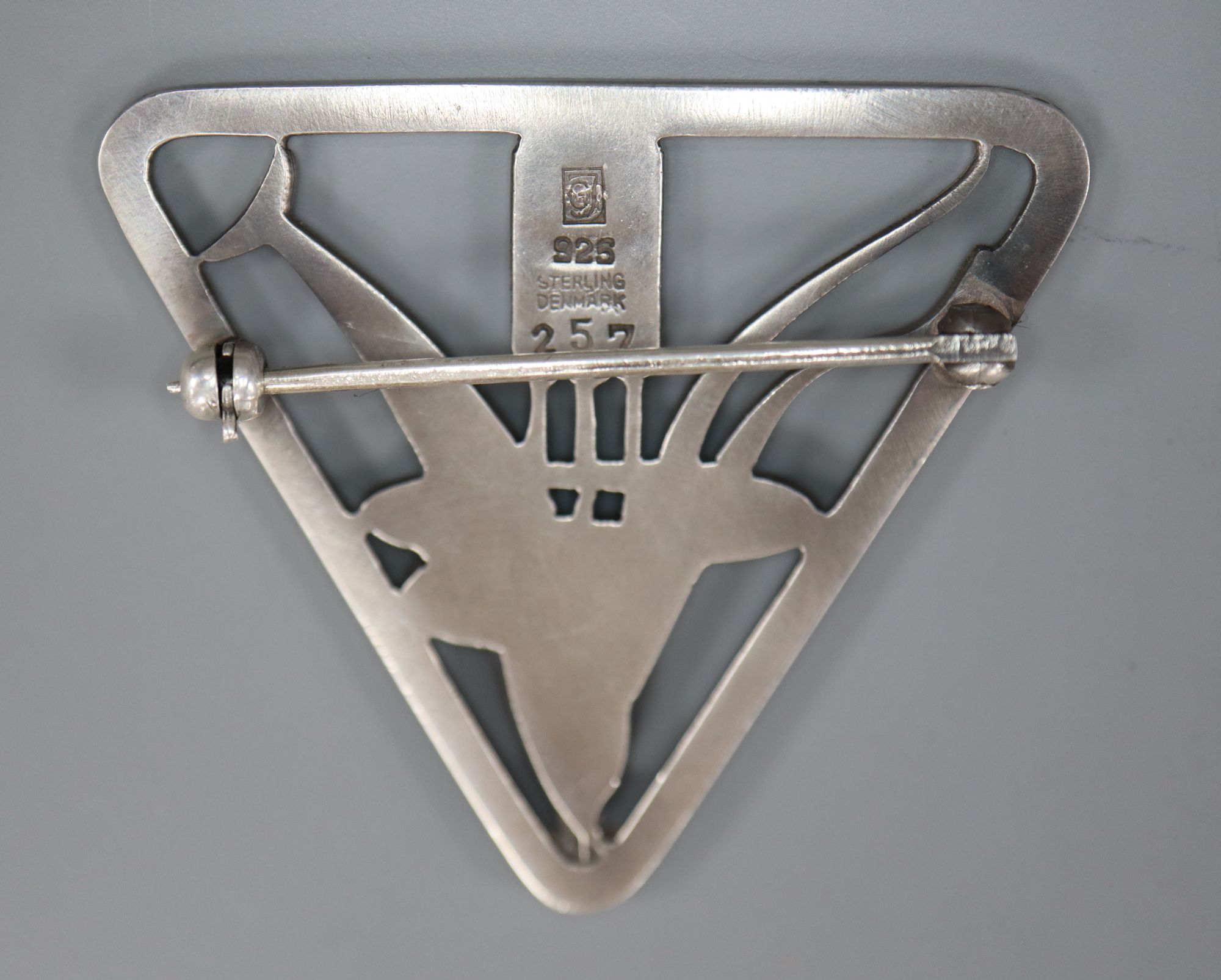 A Georg Jensen sterling Dolphin & Bulrush triangular brooch, designed by Arno Malinowski, no. 257, 37mm.
